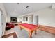Spacious game room featuring a red pool table, plush seating, and neutral carpet at 13325 W 86Th Dr, Arvada, CO 80005