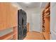 Convenient laundry room with stacked washer and dryer and plenty of storage for detergents and other supplies at 13325 W 86Th Dr, Arvada, CO 80005