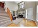 Inviting living room with wood floors, high ceilings, lots of natural light, and a staircase at 13325 W 86Th Dr, Arvada, CO 80005