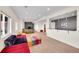 Large living room with colorful sectional seating, carpet, and a bar area in the background at 13325 W 86Th Dr, Arvada, CO 80005