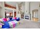 Spacious living room showcasing a fireplace, comfortable seating, and an open floor plan at 13325 W 86Th Dr, Arvada, CO 80005