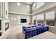 Comfortable living room featuring high ceilings, a fireplace, large windows, and scenic views at 13325 W 86Th Dr, Arvada, CO 80005