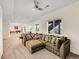 Spacious living room featuring a large sectional sofa, carpet, and bright natural light at 13325 W 86Th Dr, Arvada, CO 80005