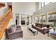Inviting living room with wood floors, high ceilings, lots of natural light, columns, and a staircase at 13325 W 86Th Dr, Arvada, CO 80005