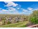 Beautiful neighborhood with lush green spaces, blue skies, and solar panels on roofs on a sunny day at 13325 W 86Th Dr, Arvada, CO 80005
