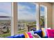 Scenic view from a living room window of the neighborhood and distant lake on a bright day at 13325 W 86Th Dr, Arvada, CO 80005