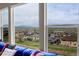 Panoramic view from a living room window of the city and mountains on an overcast day at 13325 W 86Th Dr, Arvada, CO 80005
