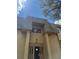 Inviting home entrance with distinctive roof design, exterior columns, and clearly marked address at 7495 E Quincy Ave # 205, Denver, CO 80237