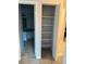 Hallway closet with shelving next to bathroom at 7495 E Quincy Ave # 205, Denver, CO 80237