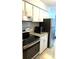 Modern kitchen featuring stainless steel appliances, white cabinets, and granite countertops at 7495 E Quincy Ave # 205, Denver, CO 80237