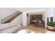 Inviting living room with modern staircase, open layout, and stylish kitchen featuring a breakfast bar at 783 E County Line Rd, Erie, CO 80516