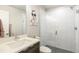 The bathroom features a modern vanity, stylish light fixtures, and shower at 3449 W 63Rd Pl, Denver, CO 80221