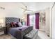 This main bedroom includes a upholstered bed, ceiling fan, and ample natural light at 3449 W 63Rd Pl, Denver, CO 80221