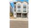 Modern townhouse boasts a two-car garage, and is painted in complimentary shades of gray and white at 3449 W 63Rd Pl, Denver, CO 80221