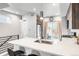 Bright kitchen featuring quartz countertops, stainless appliances, and a view of the backyard at 3449 W 63Rd Pl, Denver, CO 80221