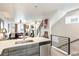 Open concept living area with a full kitchen, living room, fireplace, and staircase at 3449 W 63Rd Pl, Denver, CO 80221