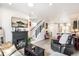 Bright living room with a dark wood fireplace, light wood floors, and access to the kitchen at 3449 W 63Rd Pl, Denver, CO 80221