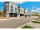 Street view of modern townhomes with gray and white exteriors and well-maintained landscaping at 3449 W 63Rd Pl, Denver, CO 80221