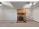Finished basement with carpet flooring and cozy brick fireplace and hearth at 12642 E Ohio Ave, Aurora, CO 80012