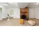 Cozy basement living space with a brick fireplace, neutral carpeting, and stylish seating arrangements at 12642 E Ohio Ave, Aurora, CO 80012