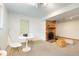 Well-lit finished basement showcasing a brick fireplace, cozy seating, and ample space for a variety of activities at 12642 E Ohio Ave, Aurora, CO 80012