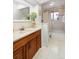 A clean bathroom showcasing a vanity with marble countertop, a sink, and a decorative plant at 12642 E Ohio Ave, Aurora, CO 80012