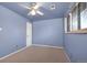 Neutral toned bedroom features a ceiling fan and natural light from the window at 12642 E Ohio Ave, Aurora, CO 80012