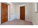 Well lit bedroom featuring a bi-fold closet and neutral carpet at 12642 E Ohio Ave, Aurora, CO 80012