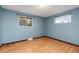 Bedroom featuring laminate floors and natural light from two windows at 12642 E Ohio Ave, Aurora, CO 80012