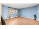 Bright bedroom with a large window, neutral paint and laminate flooring at 12642 E Ohio Ave, Aurora, CO 80012