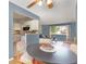 Open dining area with hardwood floors flowing into a living space with modern blue walls and an efficient layout at 12642 E Ohio Ave, Aurora, CO 80012