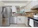 Updated kitchen features stainless steel appliances, granite countertops, and sleek cabinetry at 12642 E Ohio Ave, Aurora, CO 80012