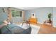 Stylish living room with a comfortable blue sofa, wood floors, and a window with natural light at 12642 E Ohio Ave, Aurora, CO 80012