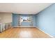Bright living room features wood floors, large windows, and neutral paint for a relaxing space at 12642 E Ohio Ave, Aurora, CO 80012