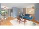 Open-concept living room boasts hardwood floors, light blue walls, and a comfortable blue velvet sofa at 12642 E Ohio Ave, Aurora, CO 80012