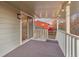 A covered patio with string lights and railing offers a view of the backyard at 12642 E Ohio Ave, Aurora, CO 80012