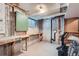 Utility basement room with a workbench and visible mechanical equipment at 9202 W Ontario Dr, Littleton, CO 80128