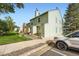 Exterior view of the side of a two-story home and part of the front yard at 9202 W Ontario Dr, Littleton, CO 80128