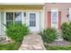 Charming entryway with a white door, well-manicured bushes, and decorative shutters at 9202 W Ontario Dr, Littleton, CO 80128