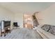 Comfortable living room with carpet, adjacent staircase, and open view to the kitchen at 9202 W Ontario Dr, Littleton, CO 80128