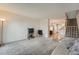Cozy living room with carpet, traditional TV, and access to stairs and kitchen at 9202 W Ontario Dr, Littleton, CO 80128