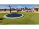 Spacious backyard with an in-ground trampoline, basketball court, and seating area for outdoor enjoyment at 14712 Kalamath Ct, Westminster, CO 80023