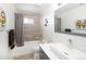 Bright bathroom with a shower/tub combo, modern vanity, and neutral tile, creating a serene space at 14712 Kalamath Ct, Westminster, CO 80023