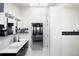 Modern bathroom with double sinks, sleek black and white design, and an open view into a serene bedroom at 14712 Kalamath Ct, Westminster, CO 80023