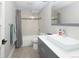 Modern bathroom featuring a sleek vanity, vessel sink, and tiled shower with neutral accents and stylish fixtures at 14712 Kalamath Ct, Westminster, CO 80023