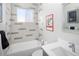 Modern bathroom with a shower-tub combination, white tile with grey accents, and sleek fixtures at 14712 Kalamath Ct, Westminster, CO 80023