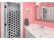 Pink bathroom featuring a tub/shower with a patterned curtain and vanity with mirror at 14712 Kalamath Ct, Westminster, CO 80023