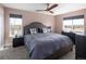 Tranquil bedroom featuring a queen-sized bed, soft pink walls, and plenty of natural light from dual windows at 14712 Kalamath Ct, Westminster, CO 80023