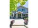 Charming home entrance with beautiful masonry, potted flowers and Adirondack chairs on the front porch at 14712 Kalamath Ct, Westminster, CO 80023
