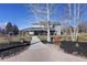 Beautiful home exterior with a landscaped yard, mature trees, and a walkway leading to a covered porch at 14712 Kalamath Ct, Westminster, CO 80023